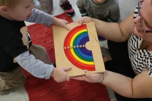 A child working with Montessori sensorial materials, such as color tablets to explore shades.