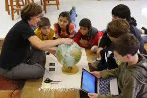 Children practicing grace and courtesy exercises in a Montessori setting, fostering social skills.
