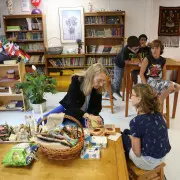 Children collaborating on a group project with Montessori cultural materials, exploring global diversity.