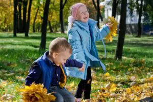Children practicing grace and courtesy exercises in a Montessori setting, fostering social skills.