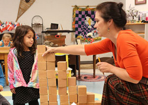 A Montessori toddler shelf, carefully organized with hands-on learning materials accessible to children.